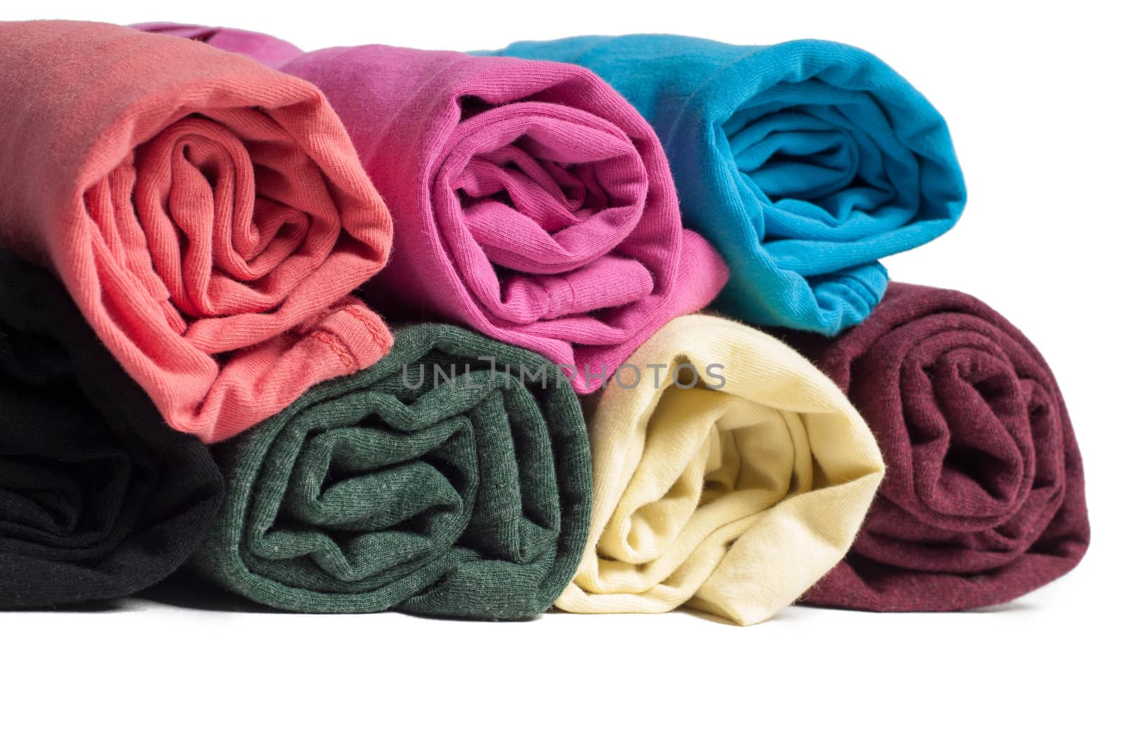 Rolls of multicolored clothes isolated on white