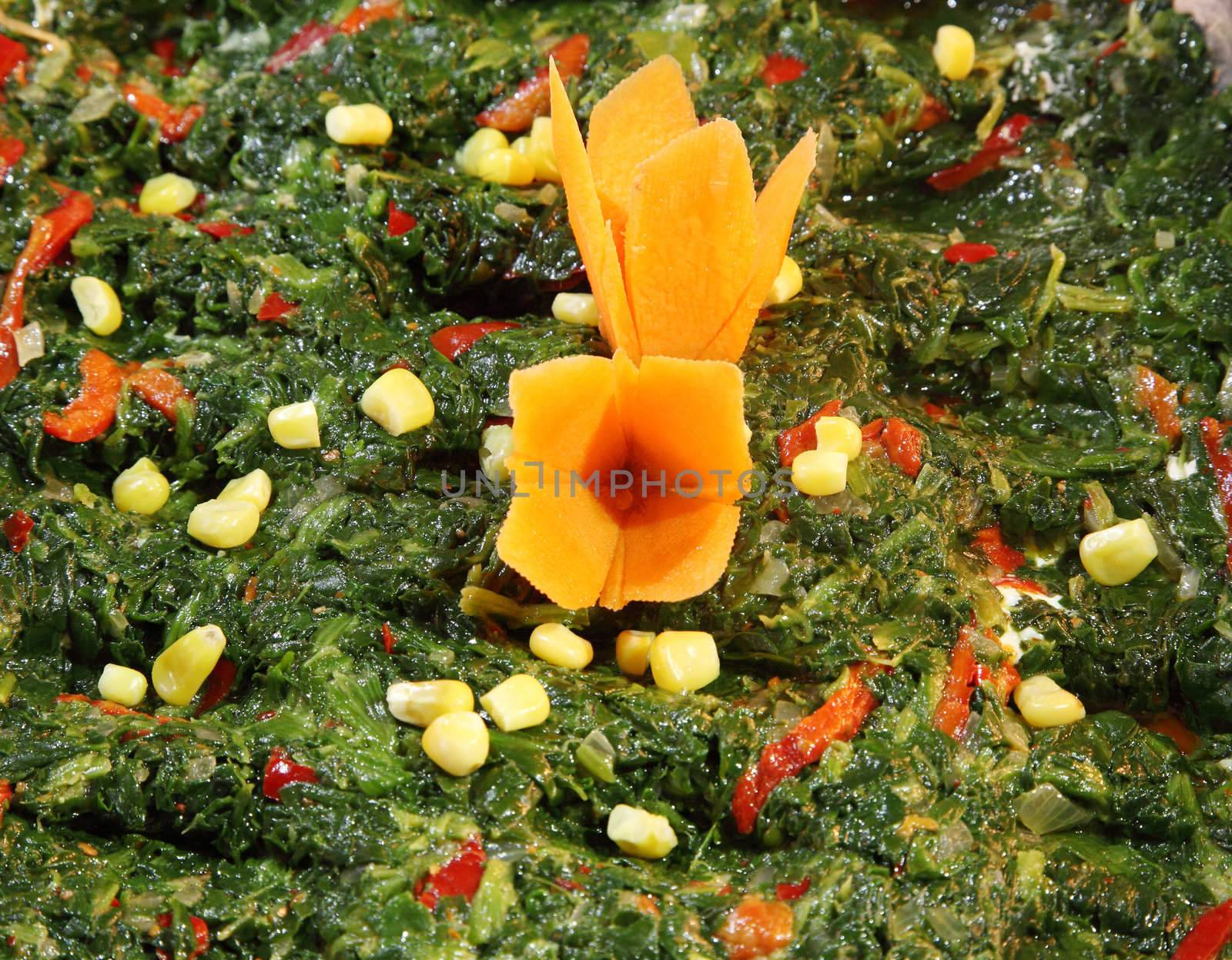 Spinach salad coocked with corn and carrot