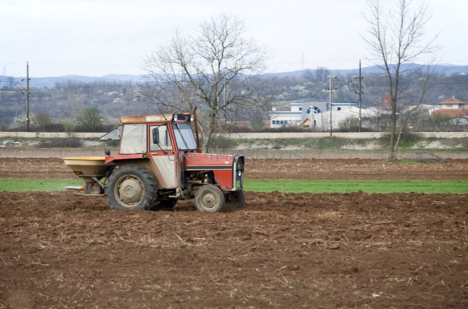 an old tractor is working on a field