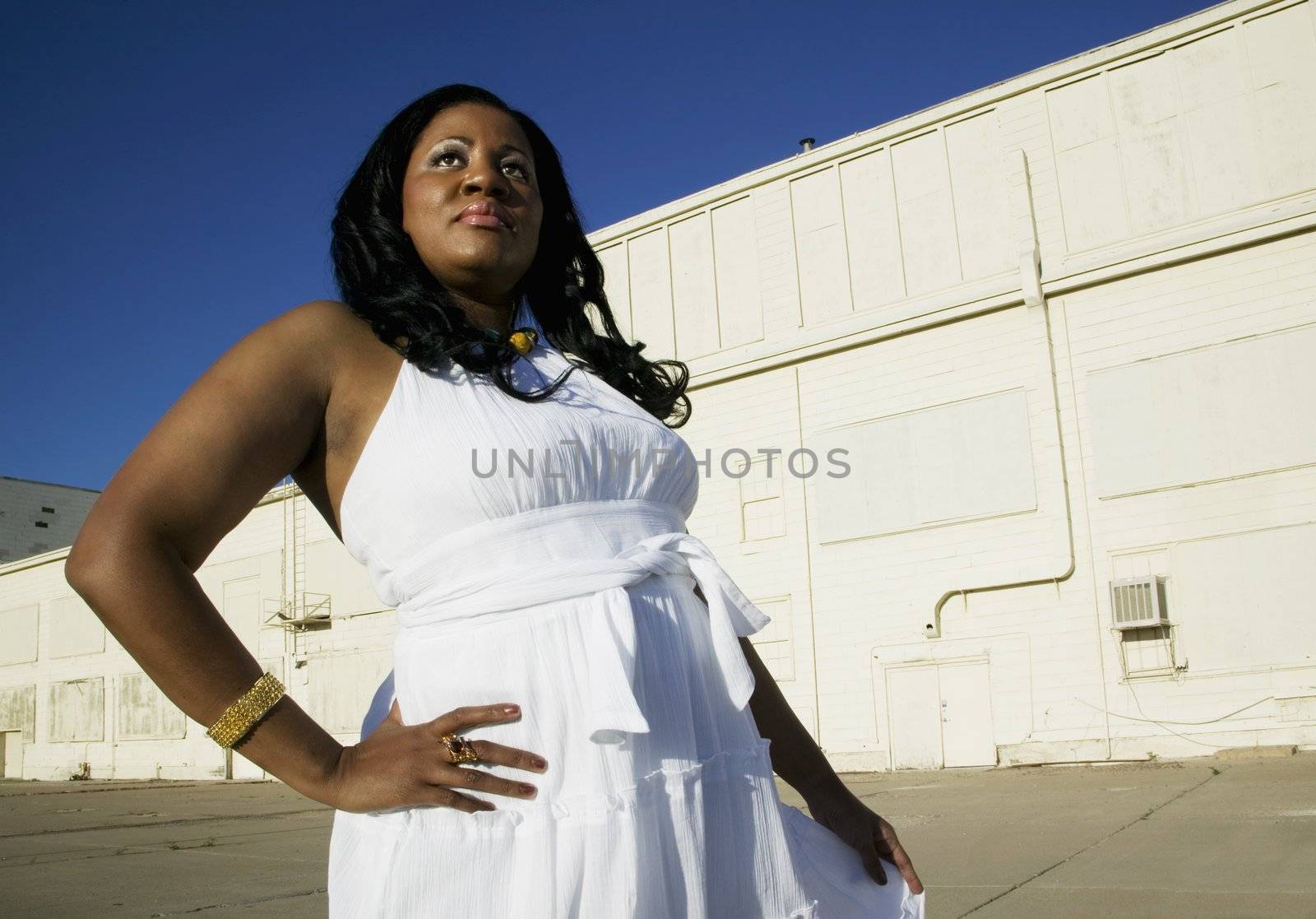 Medium shot of an African American woman at an industrial building.