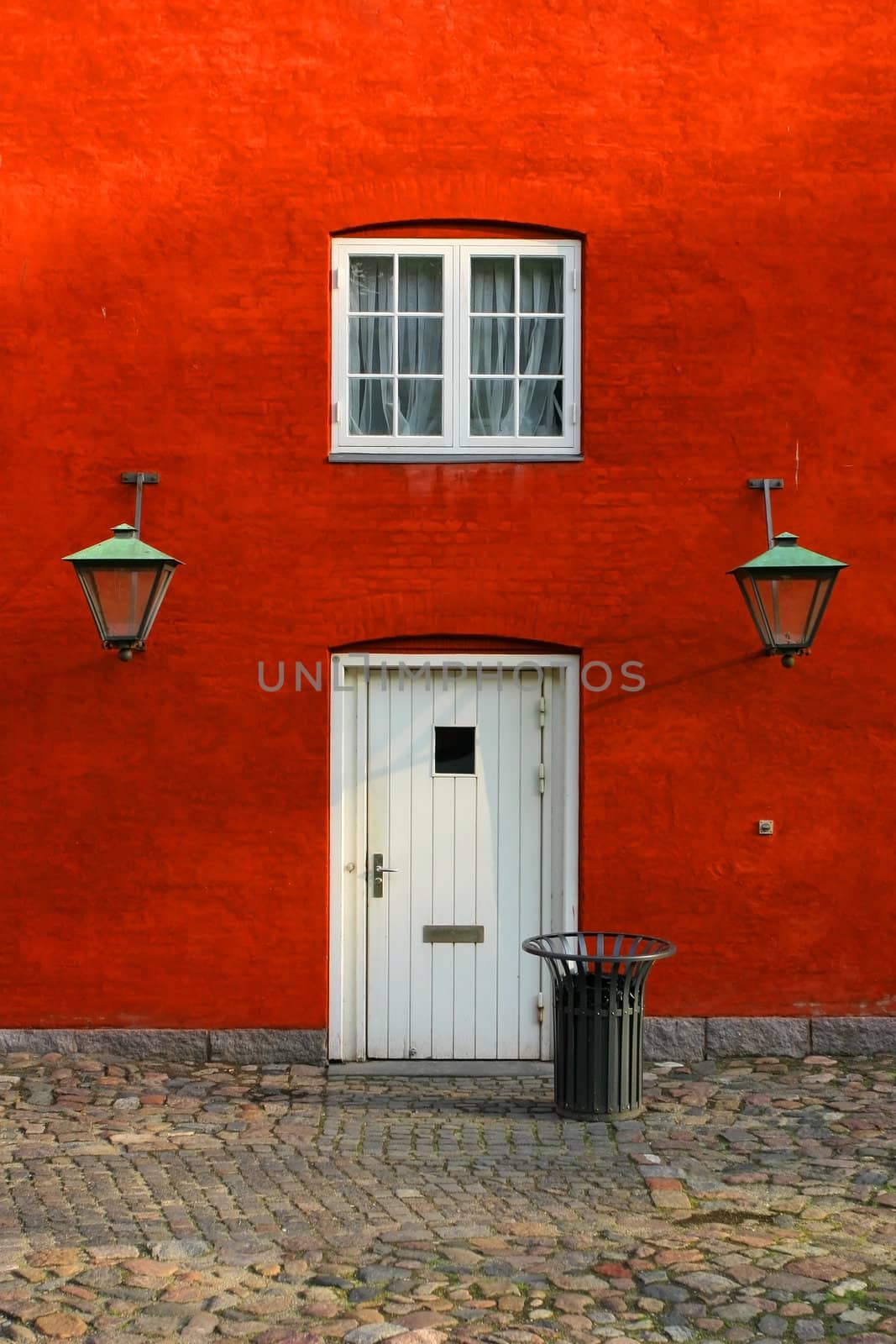 Red bulding with white door and windows.