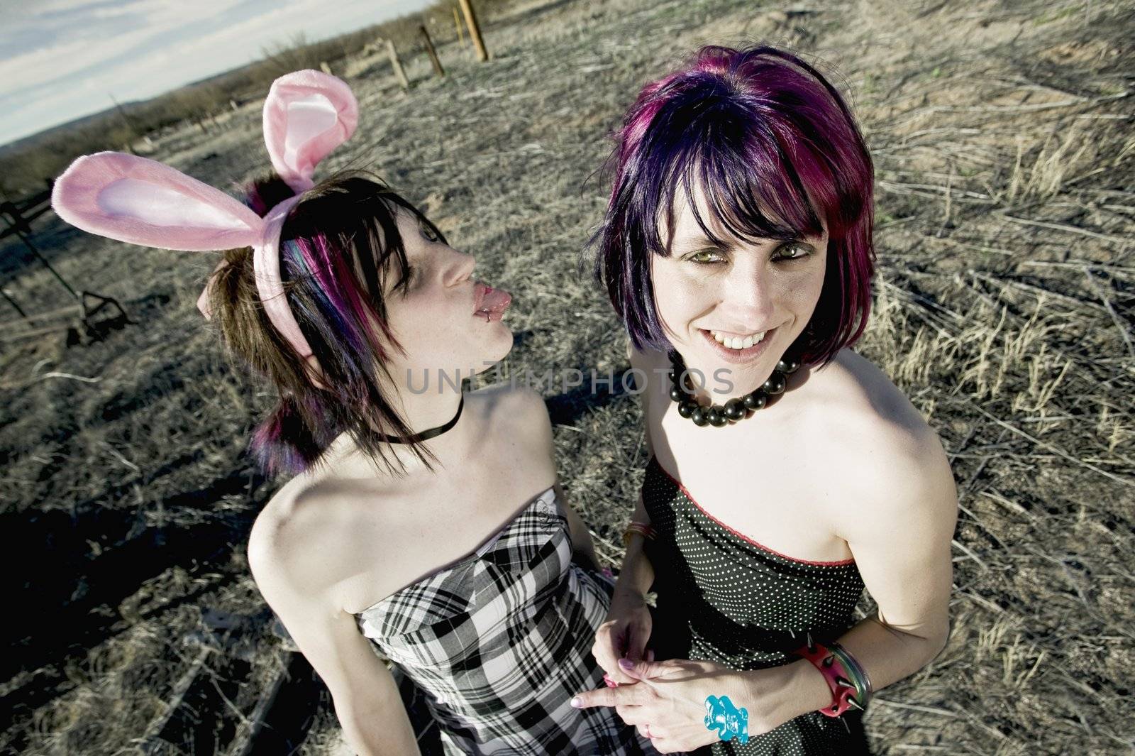 Punk girl sticking her tongue out at her friend