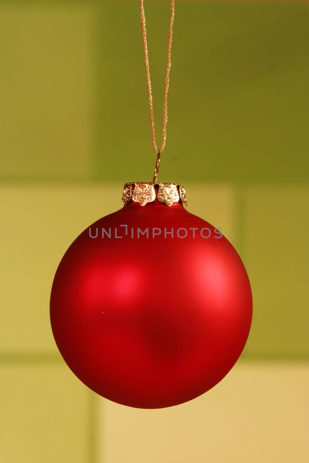 Red ornament on light green background.