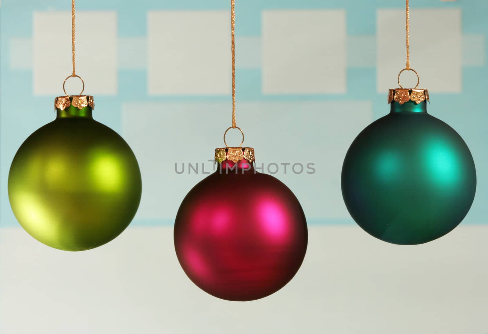 Three colorful ornaments on light blue background.