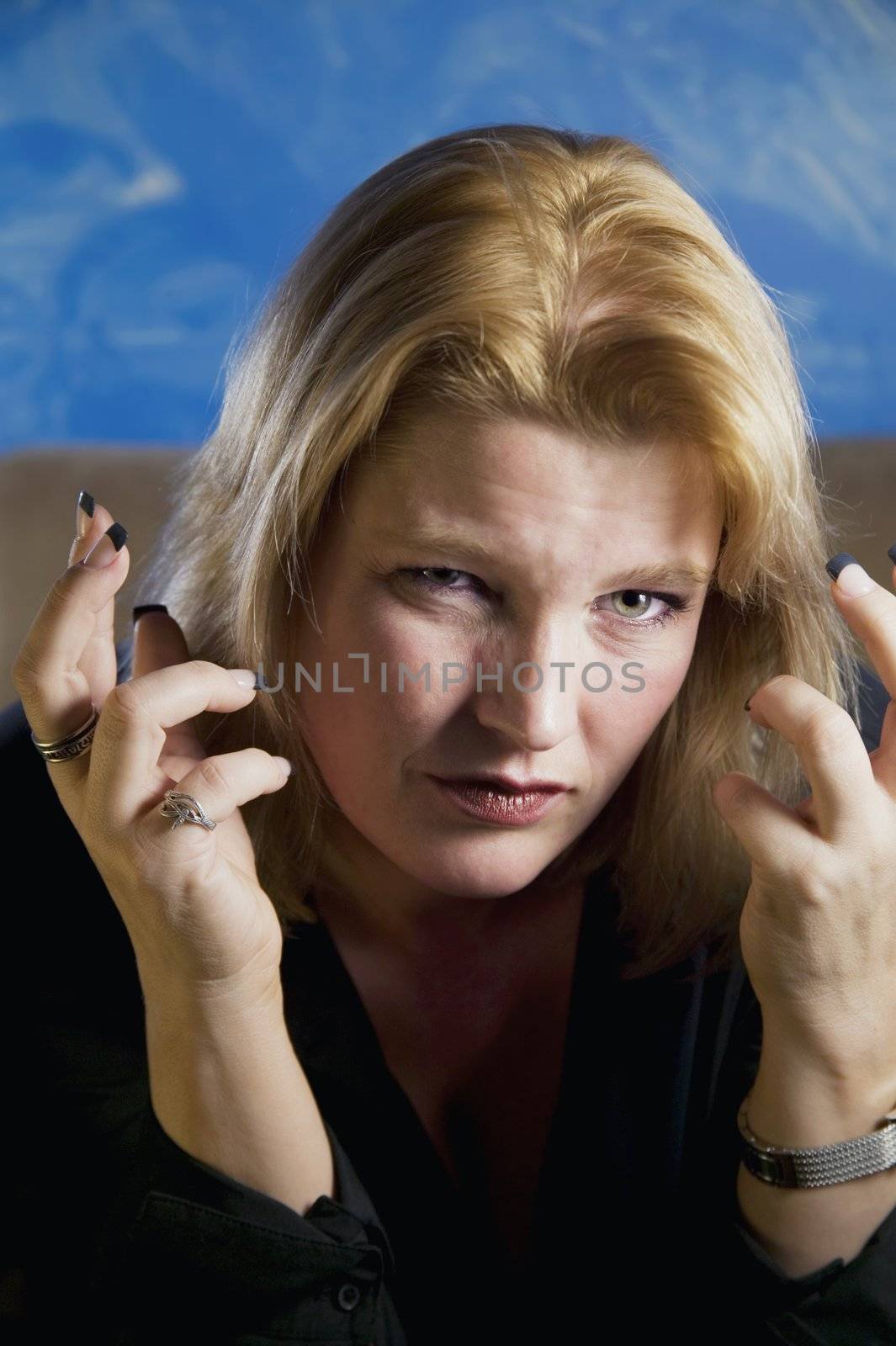 Close up of frustrated blonde woman in a studio. 