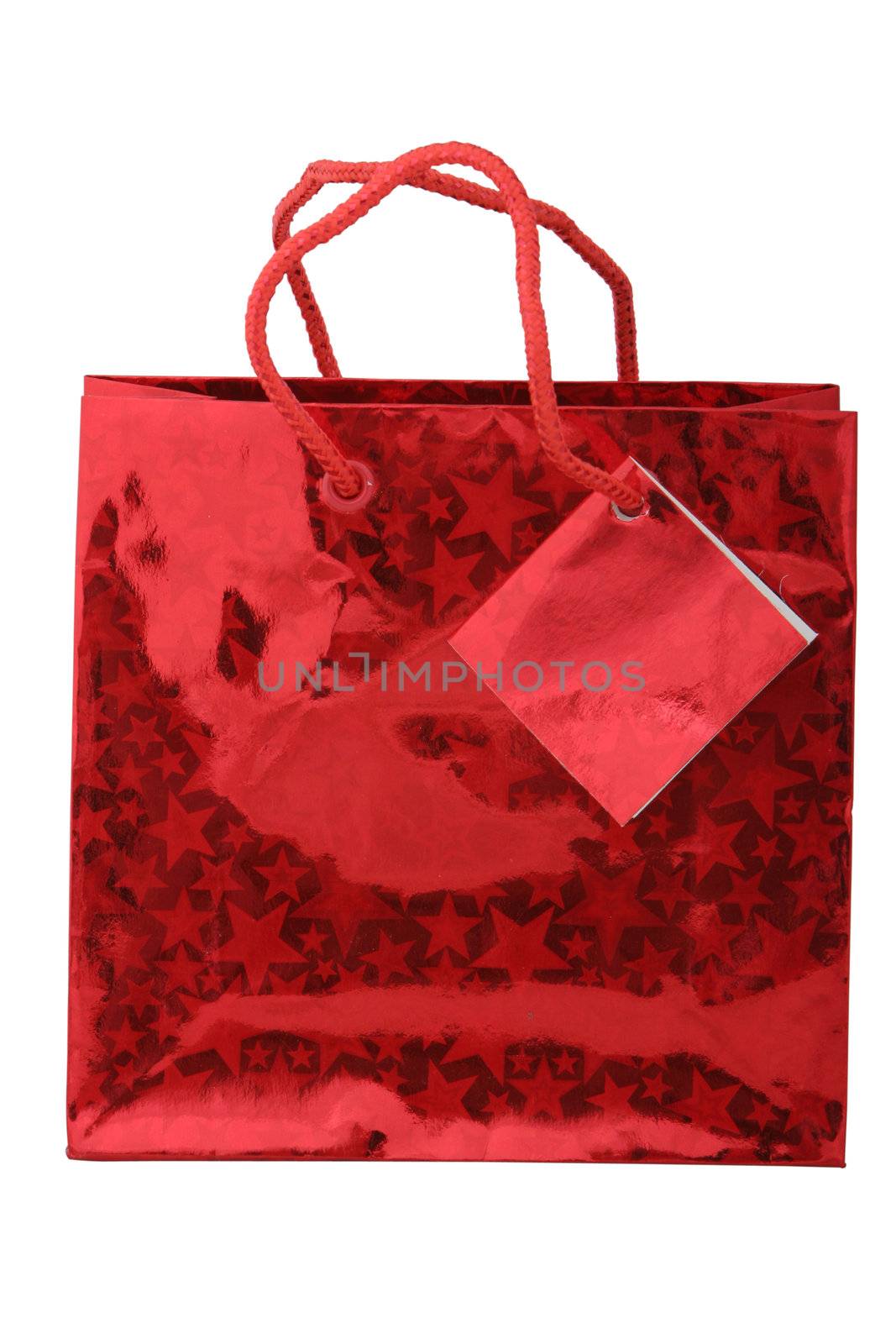 A red metalic giftbag with stars and a labeltag