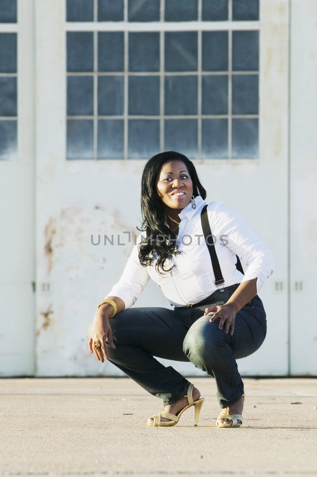 Medium shot of an African American woman at an airplane hangar.