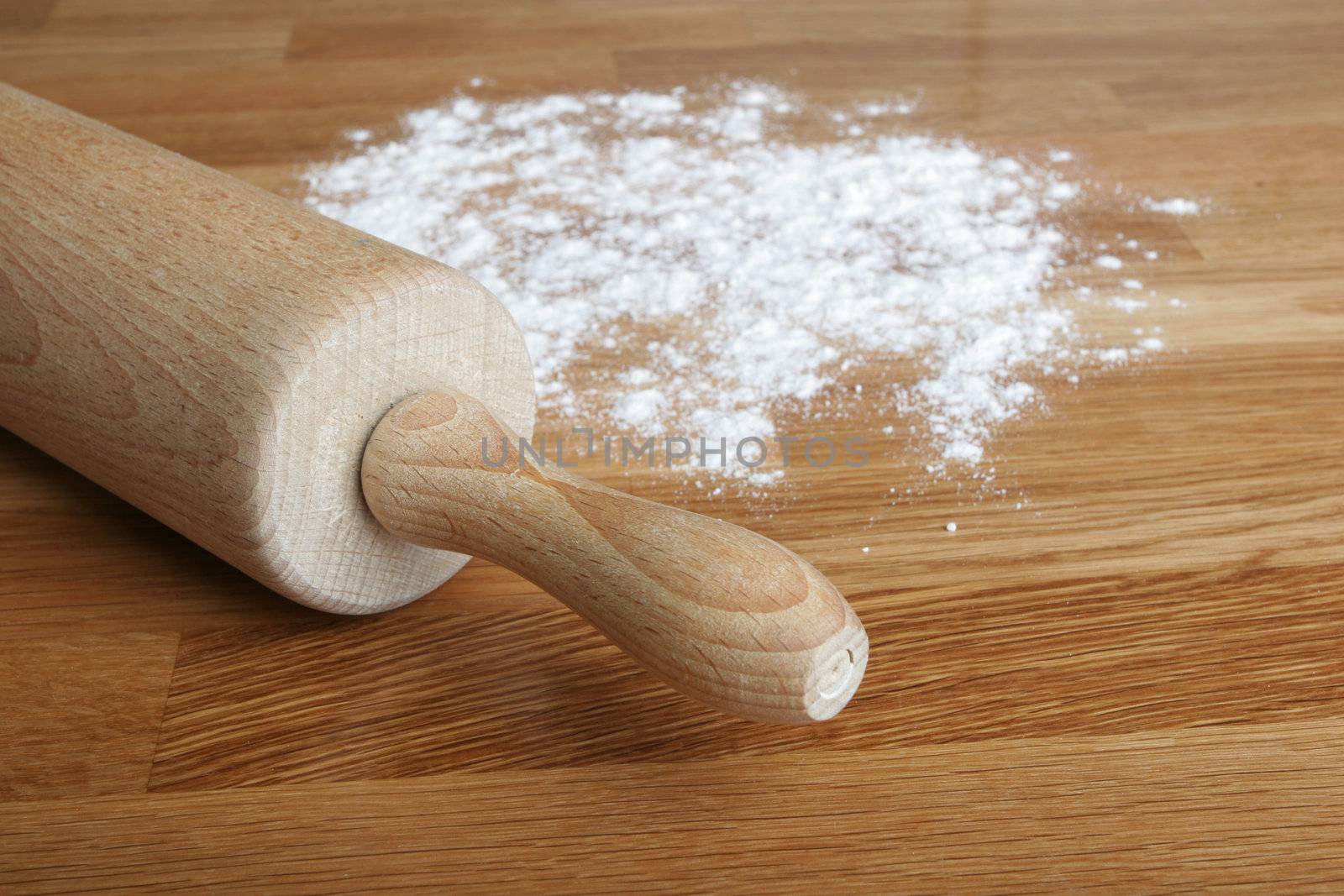 flour and rolling pin on wooden counter