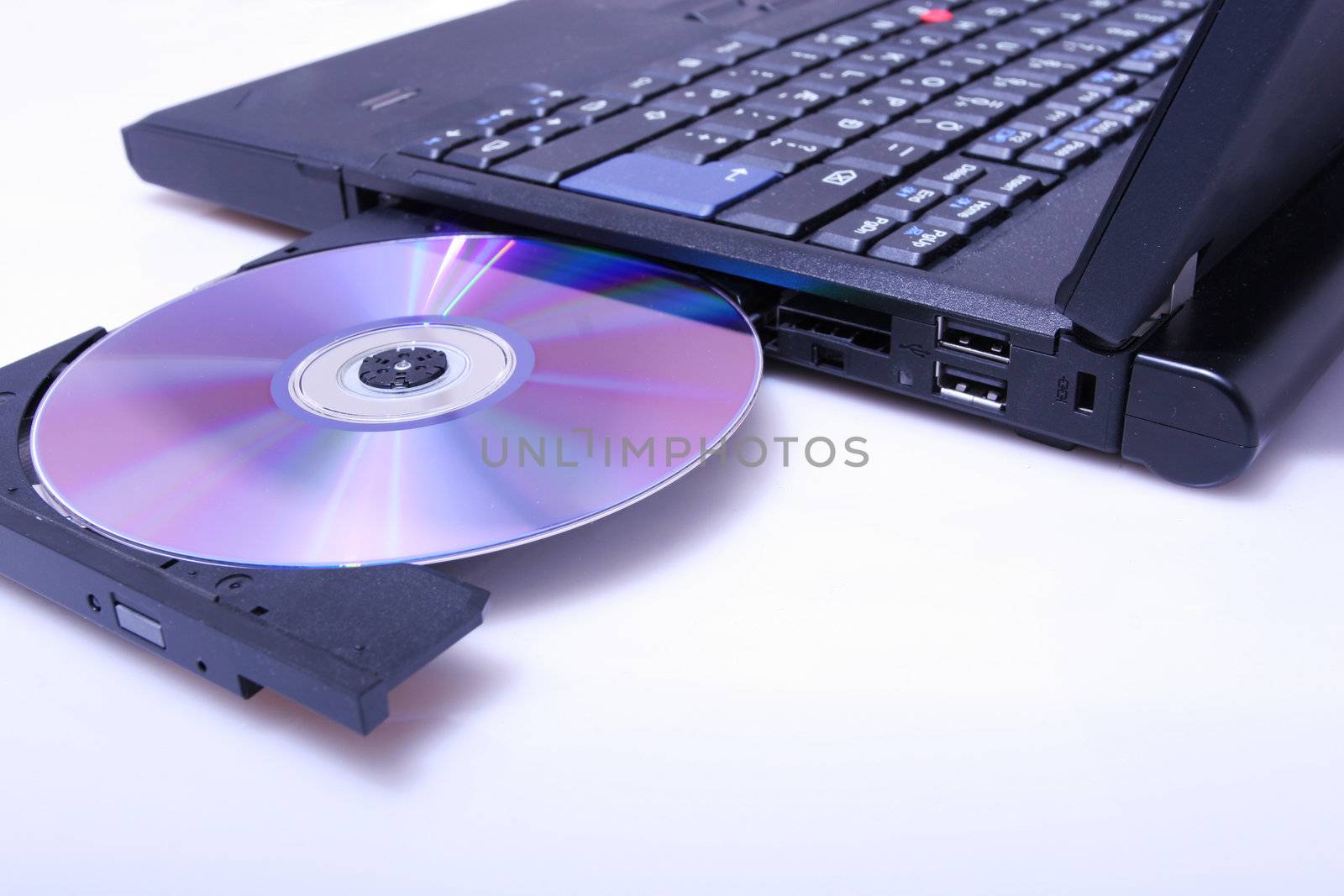 brand new laptop with cd in open cd drive, shot on white