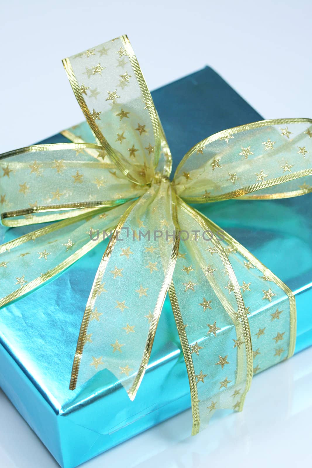 Elegant blue present wrapped with golden ribbons