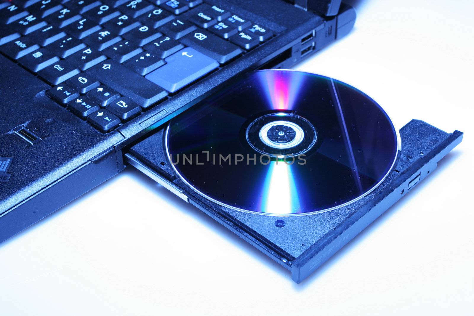 brand new laptop with cd in open cd drive, shot on white