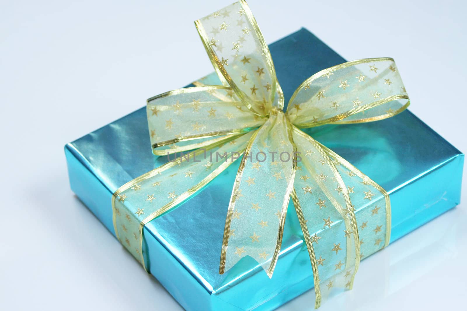 Elegant blue present wrapped with golden ribbons