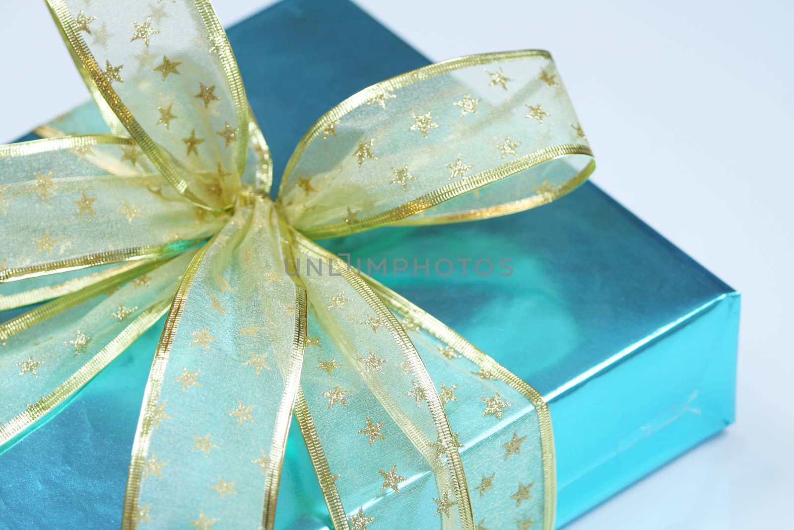 Elegant blue present wrapped with golden ribbons