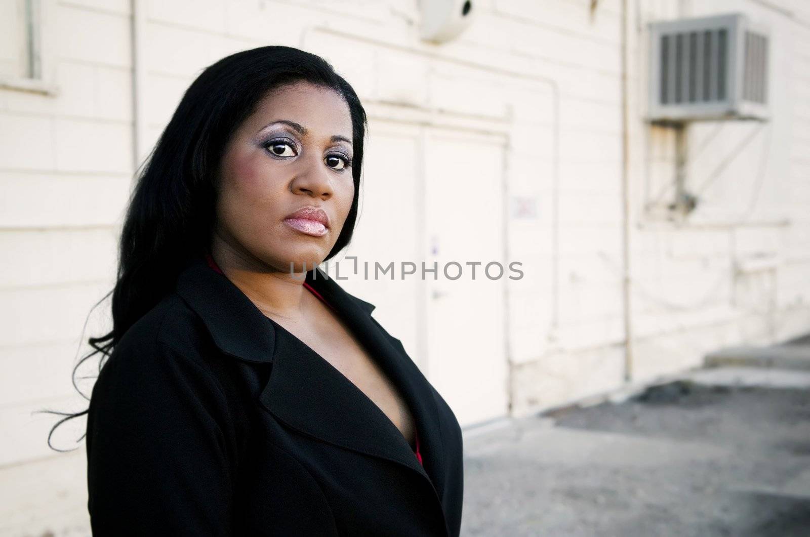 African America business woman in front of an industrial building.