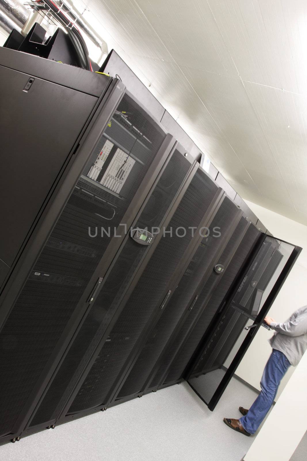 System administrator working on a server in server room