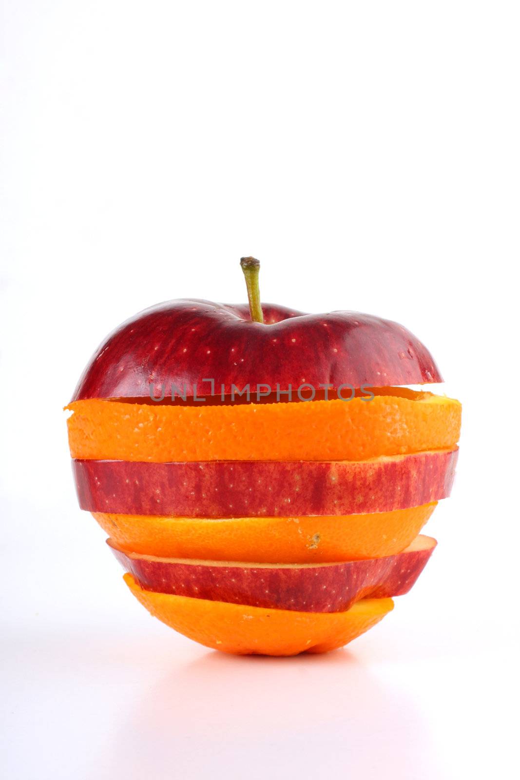 slices of an apple and orange put together to form a hybrid fruit, shot on white in a studio