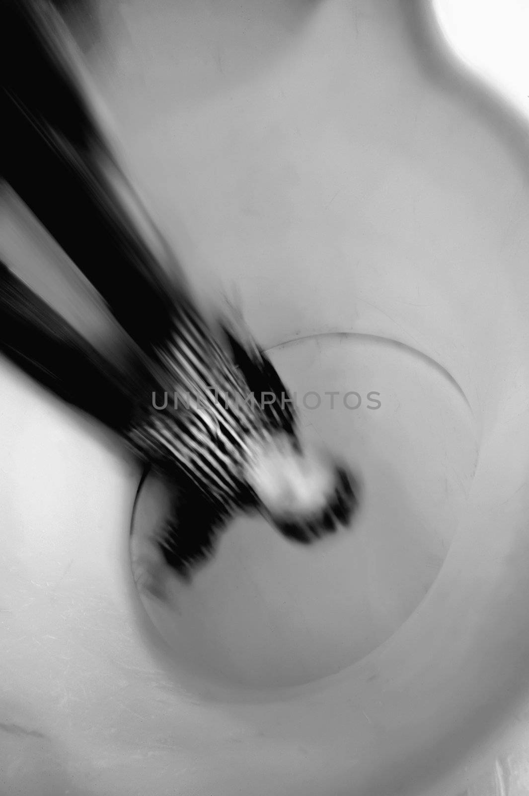 Boy slides down an orange tube slide with motion blur.