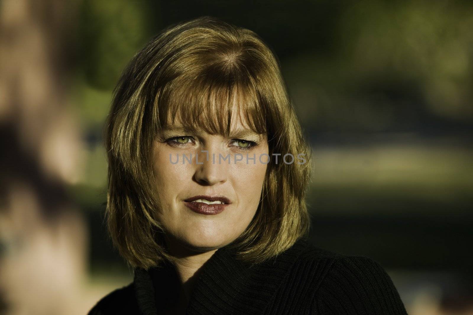 Blonde woman model with green eyes and a neutral expression