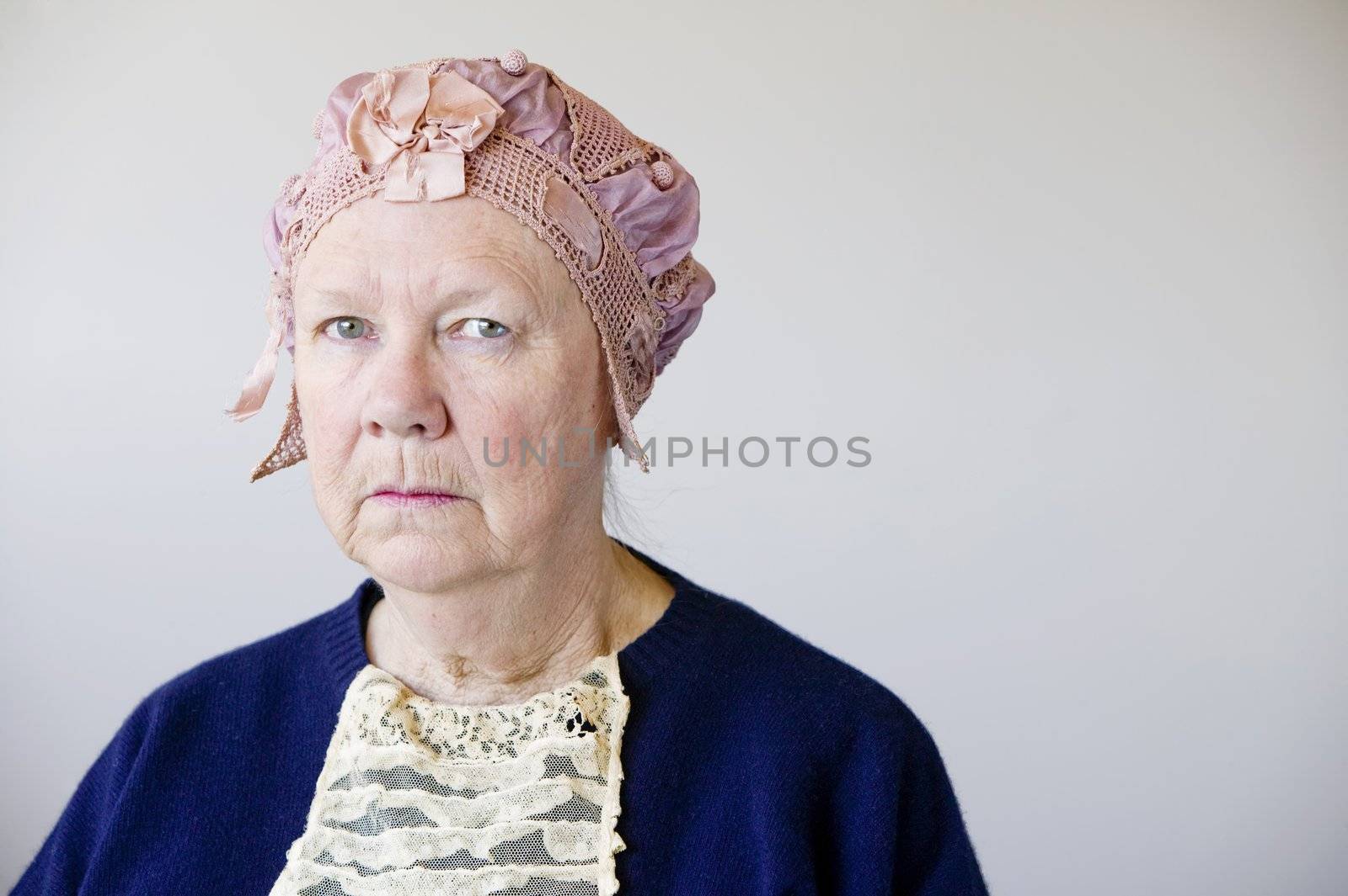Senior woman with a vintage hat by Creatista