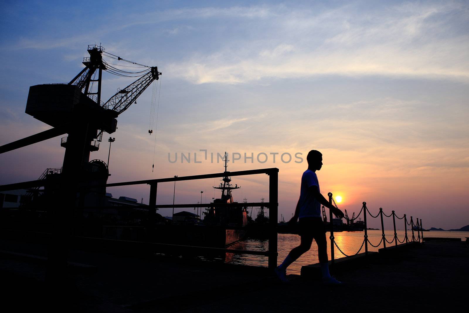 Cranes in dockside at sunset
