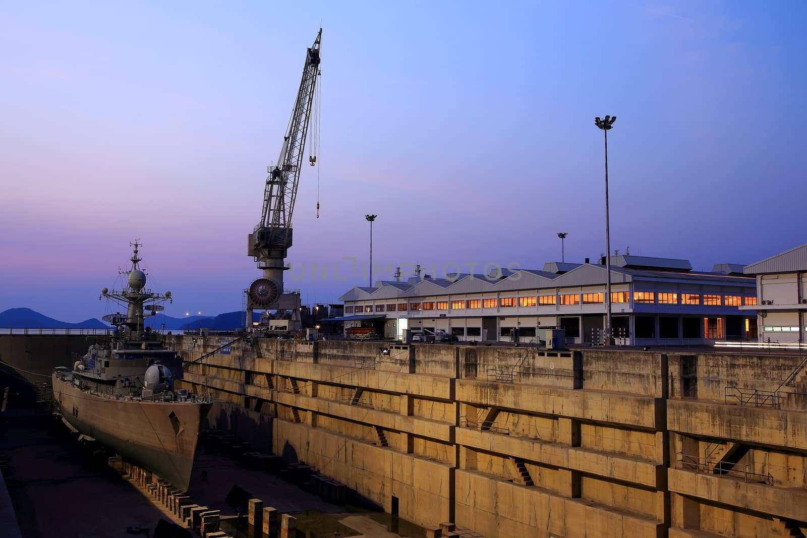 Crane near a covered dry dock at the shipyard