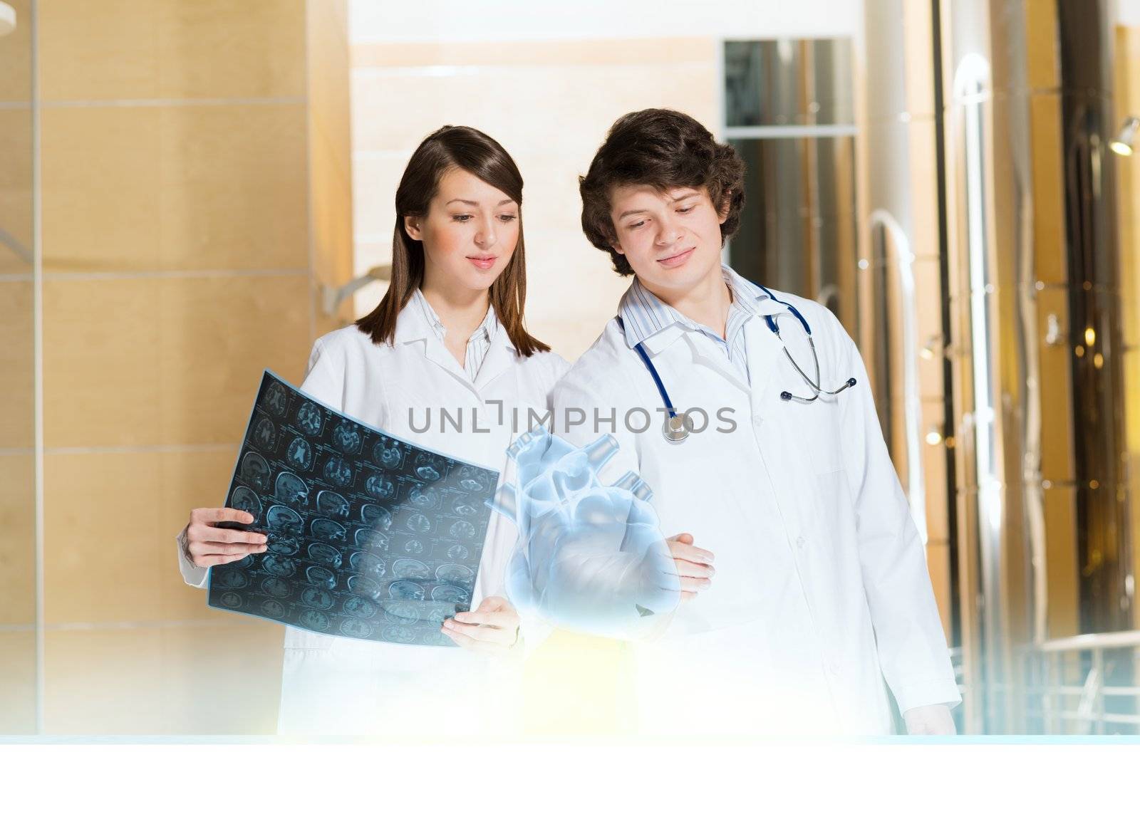 two doctors stand near glowing table discussing. projected objects on a desk