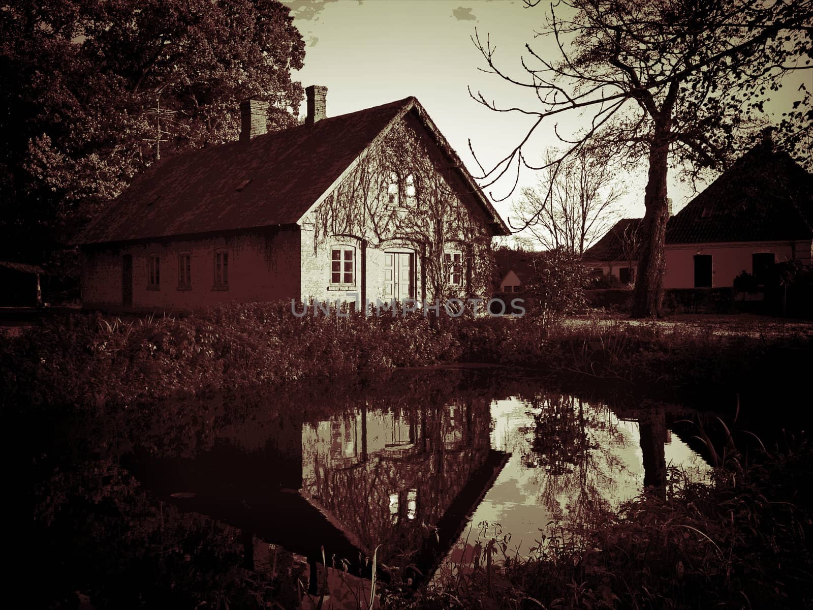 Beautiful countryside house reflected in a lake Denmark digital art manipulation