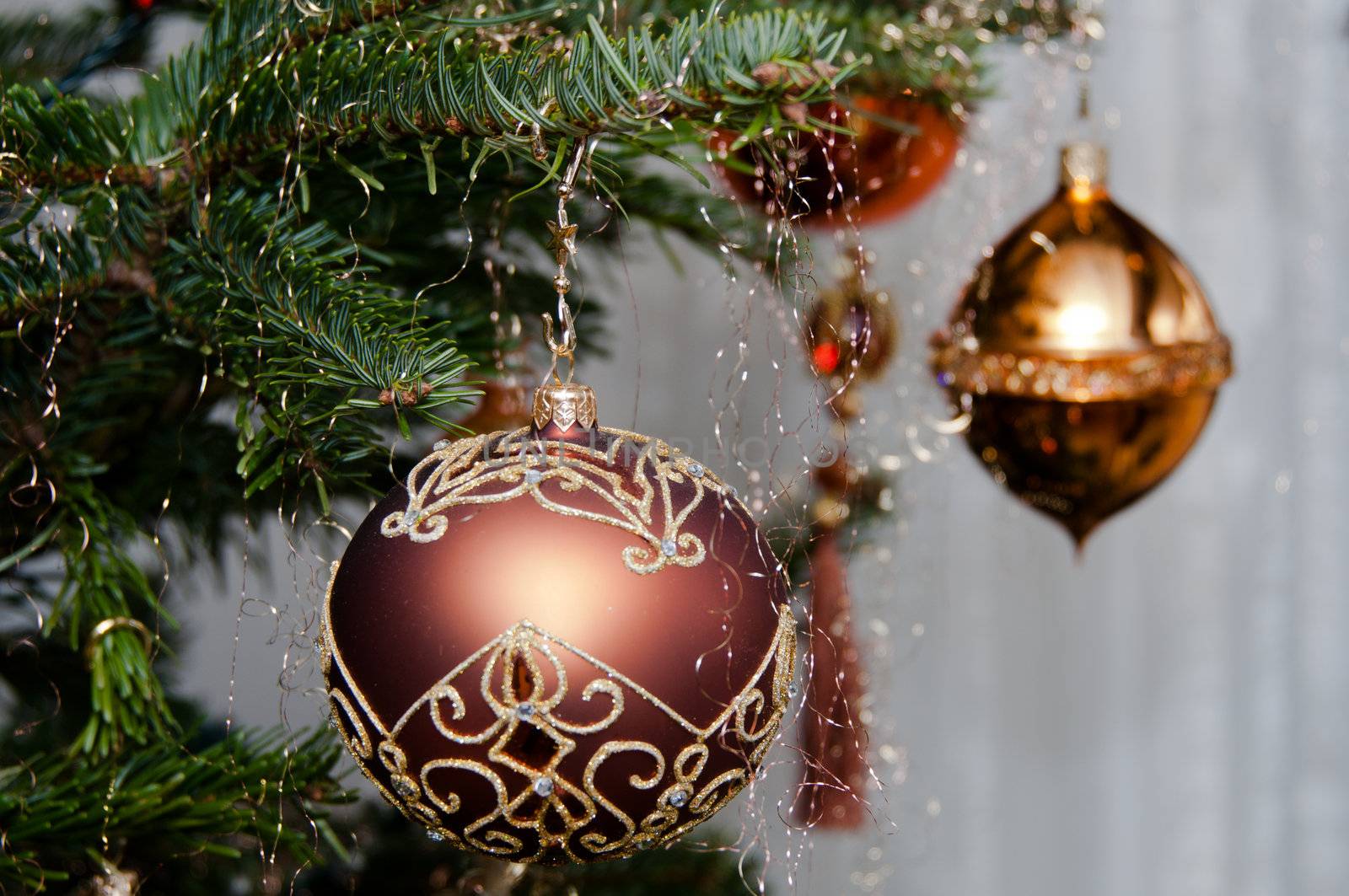 Decorative Christmas balls hanging on pine - tree branch