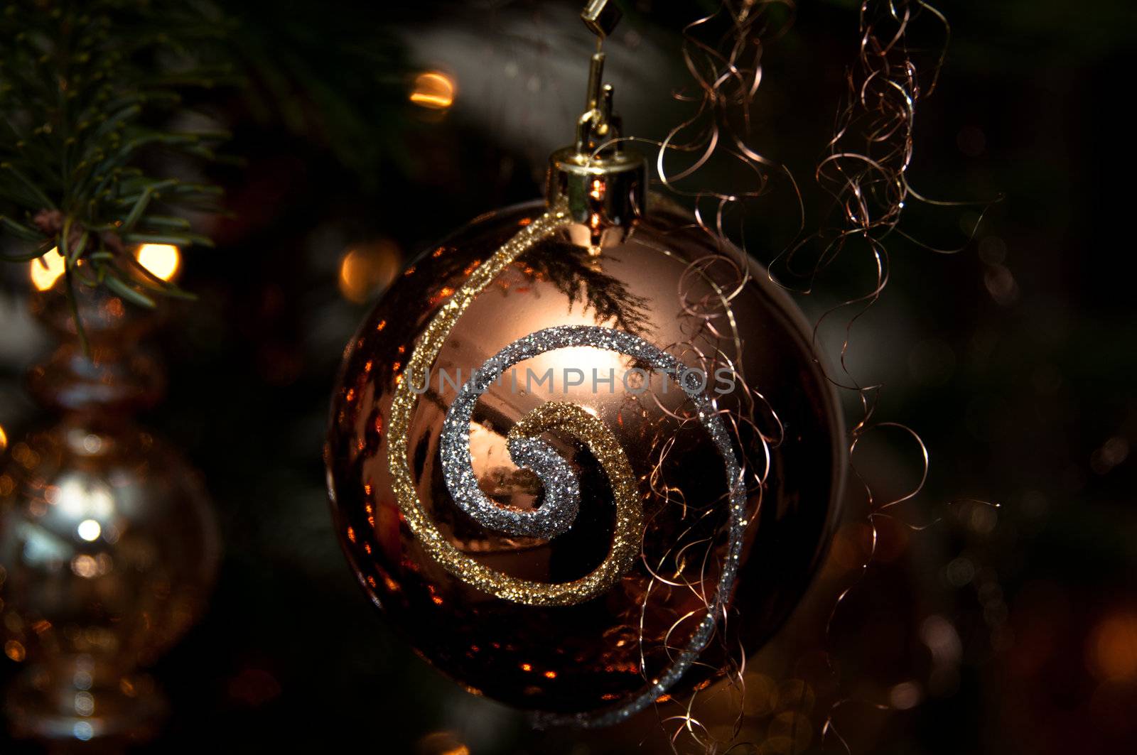 Decorative christmas ball hanging on pine - tree branch