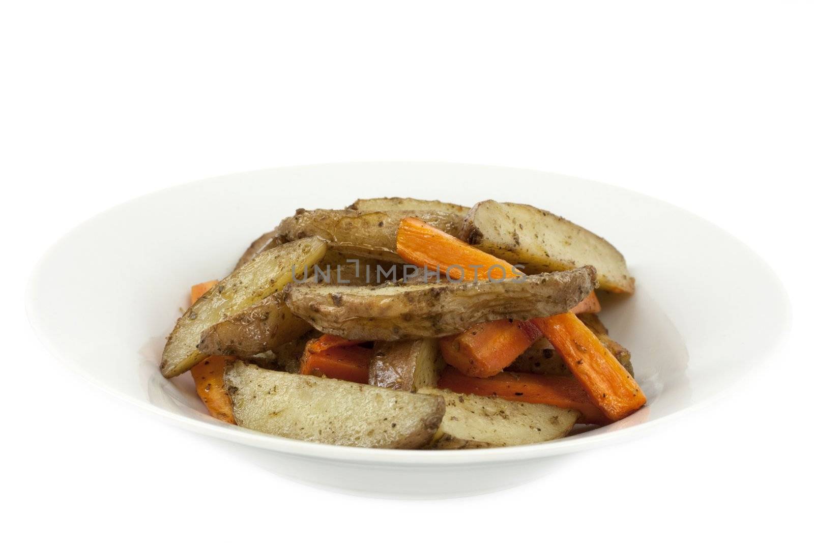 Plate full of golden fried potatoes and carrots on white