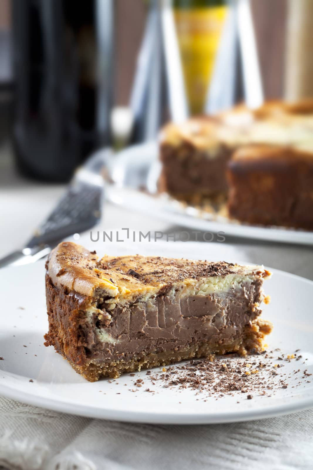Slice of chocolate cheesecake with out of focus background.