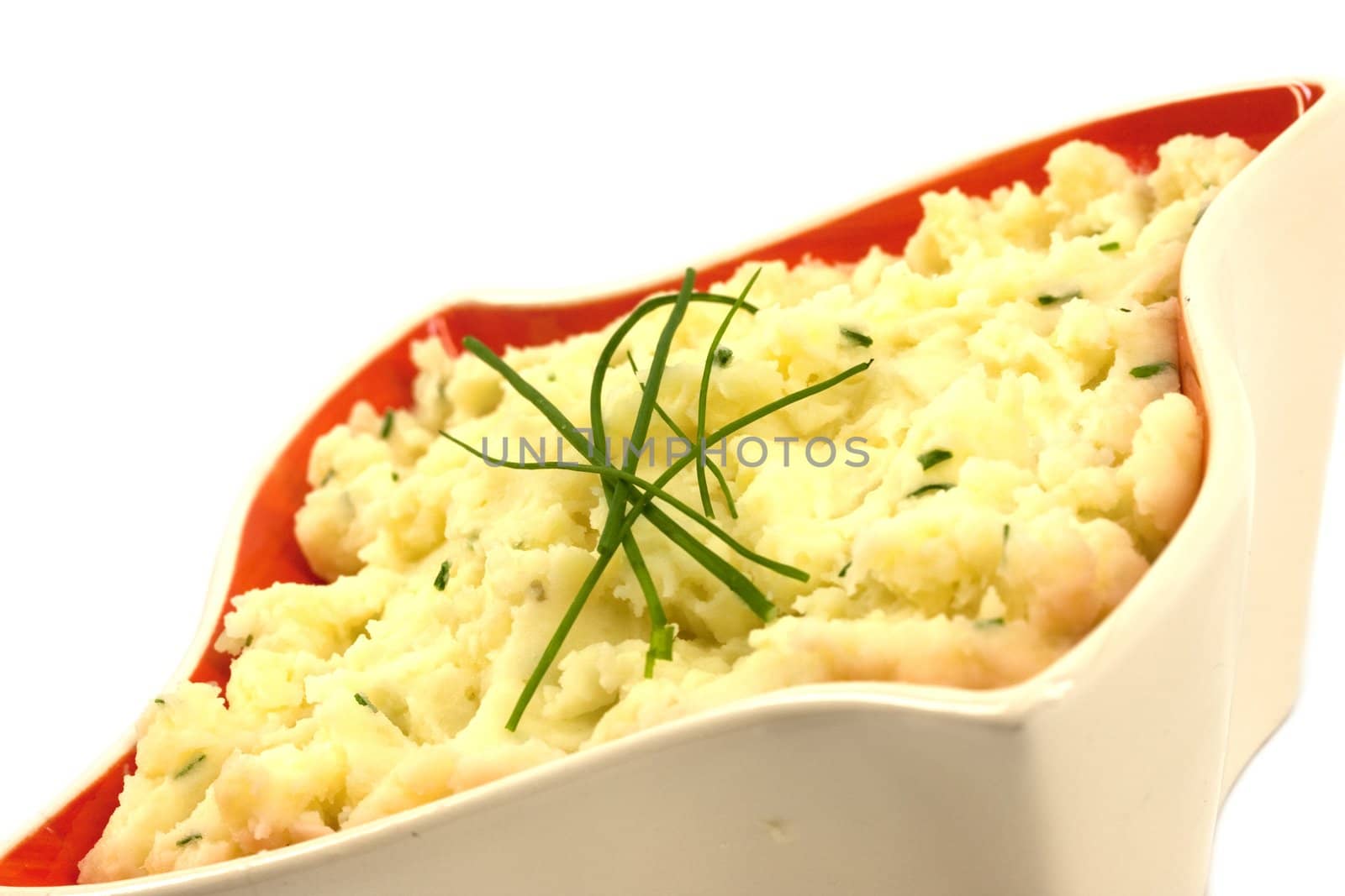 Mashed potatoes with chives in a retro orange bowl