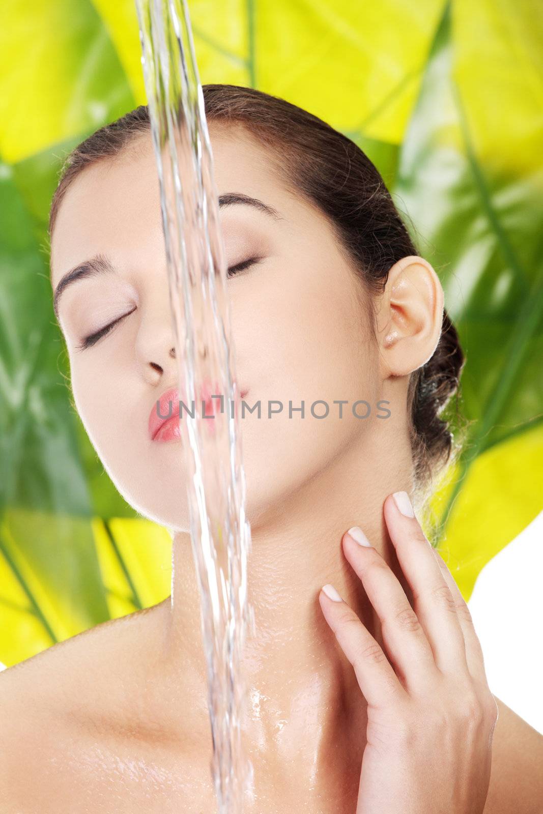 Portrait of beautiful clean face of woman under the stream of water