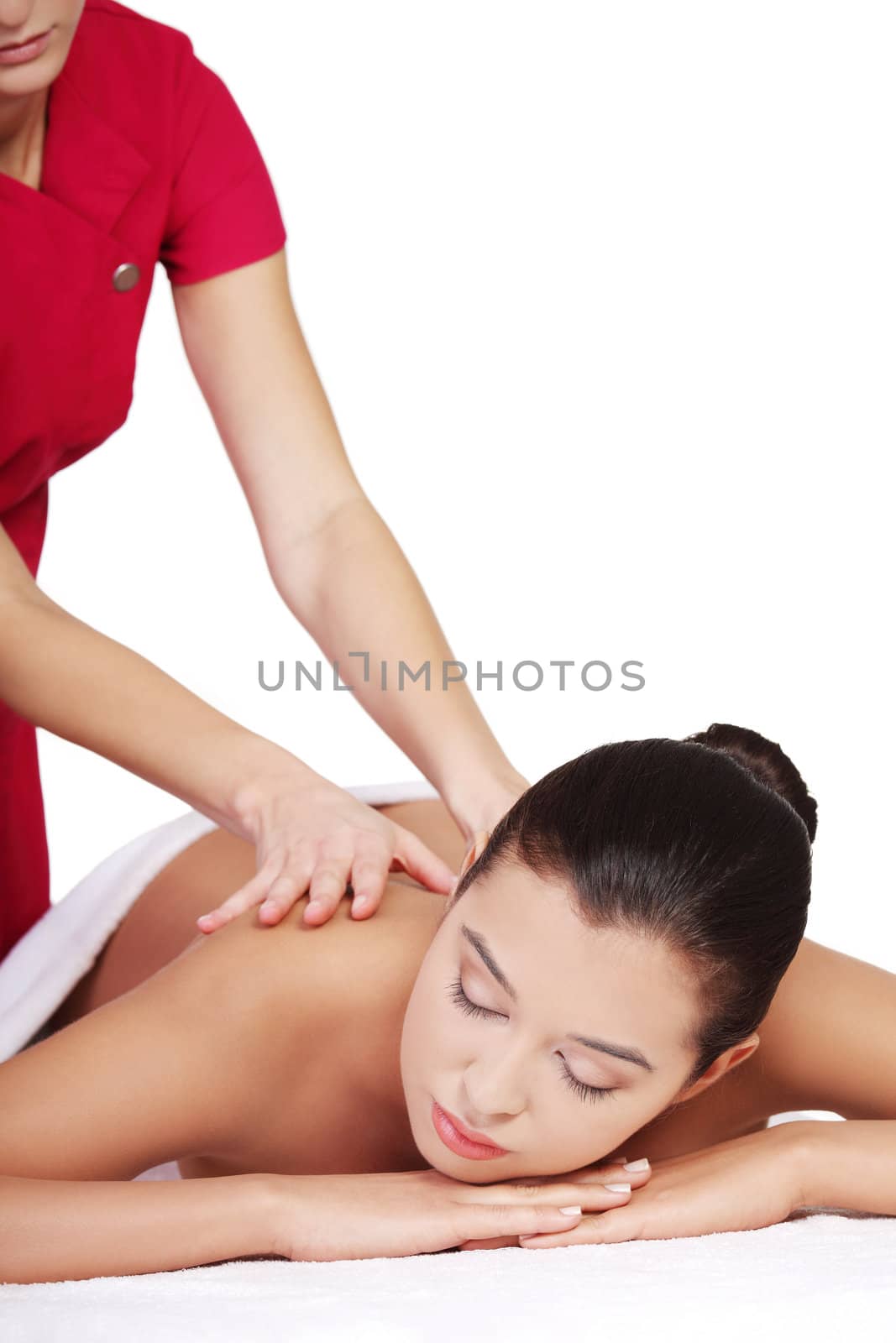 Pretty young woman relaxing being massaged isoalted on white