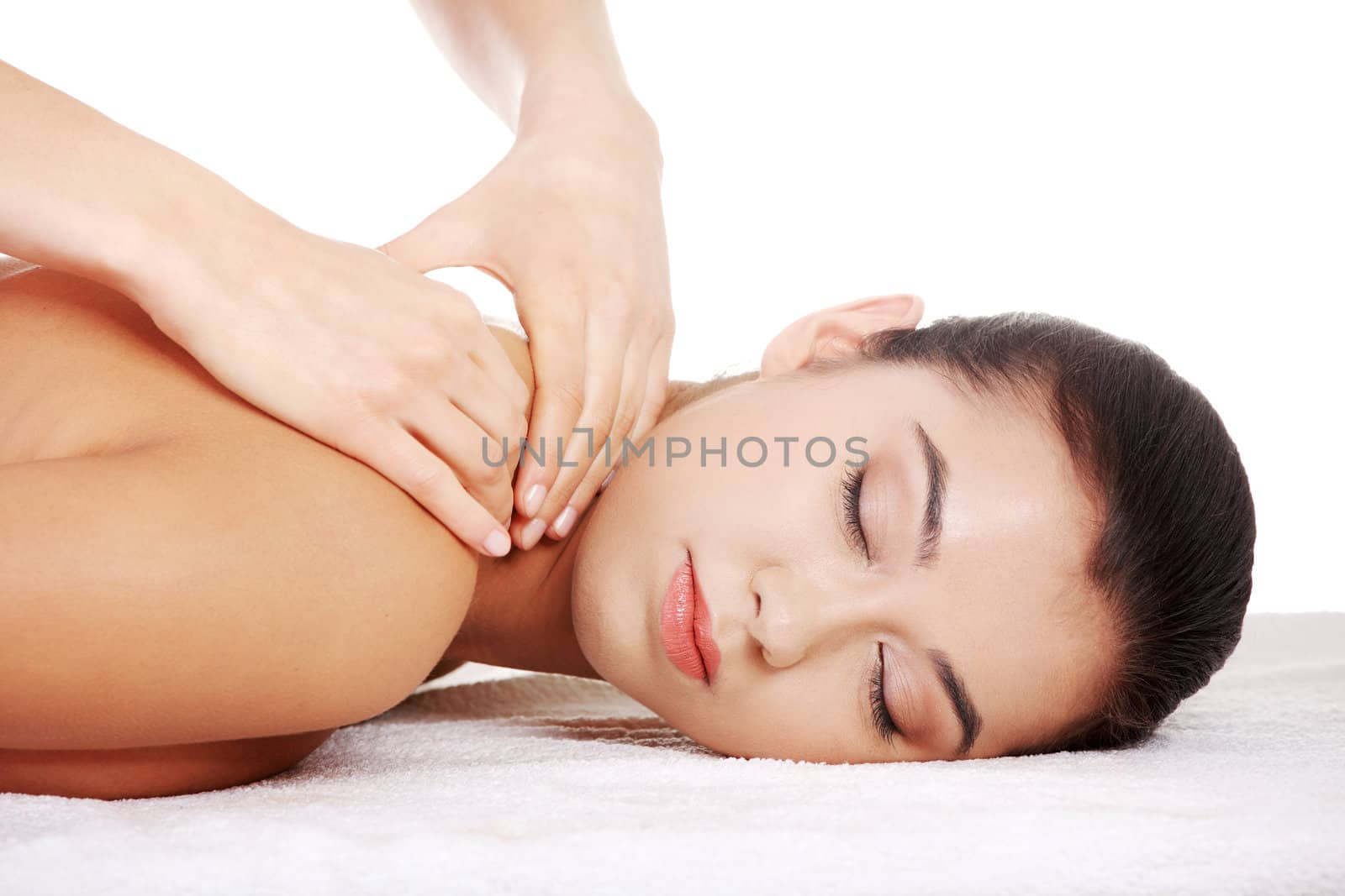 Preaty young woman relaxing beeing massaged in spa saloon