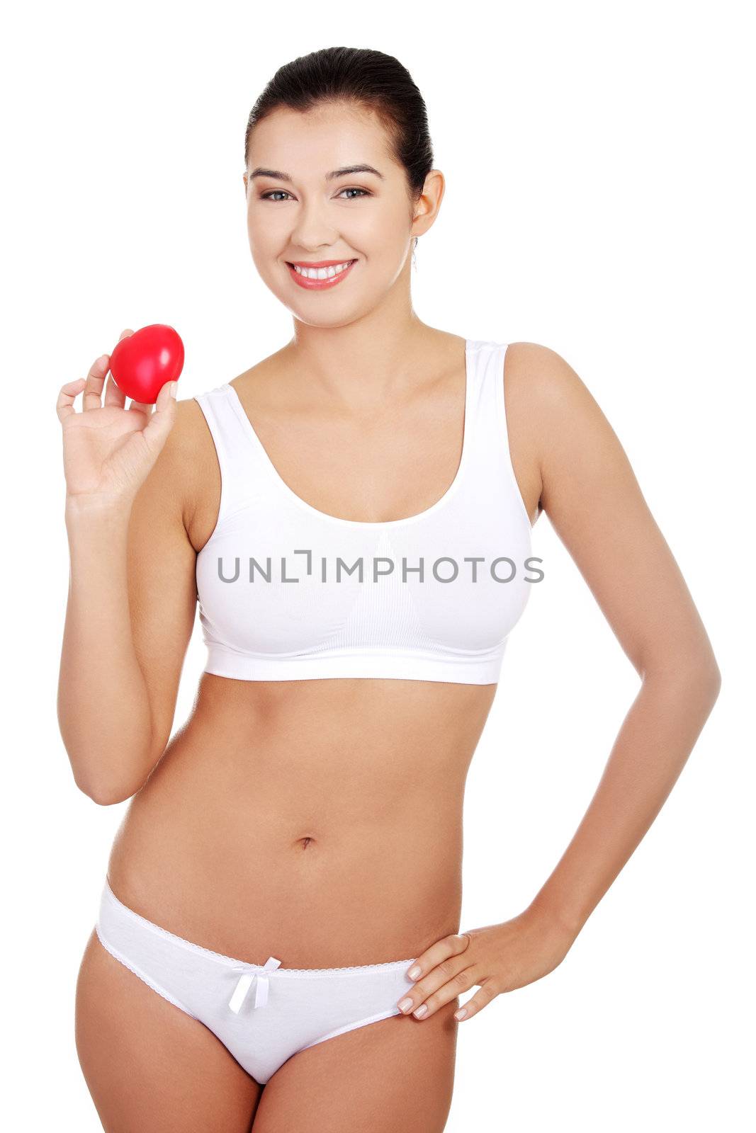 Happy Fit female in white sport underwear with red heart shaped toy