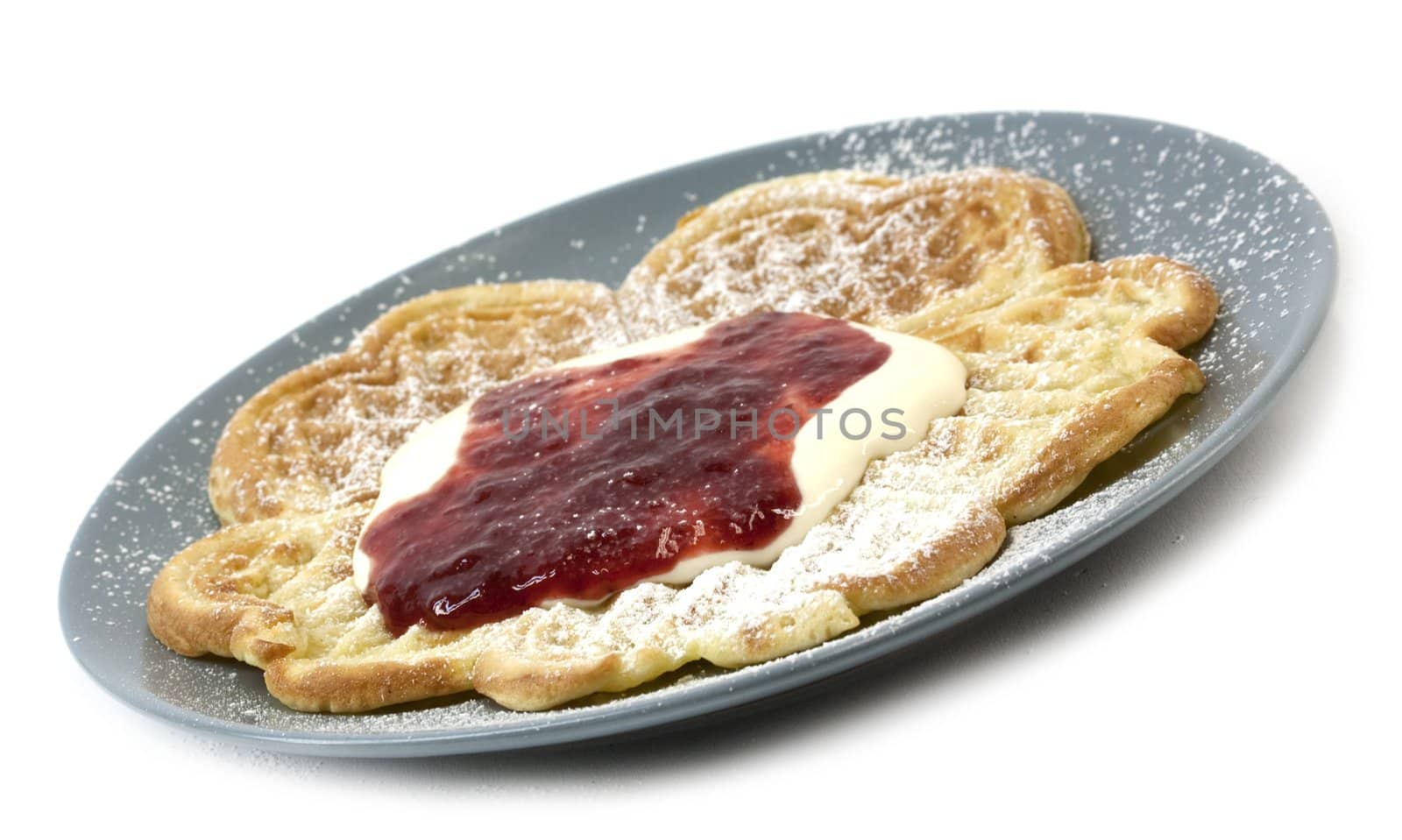 Traditional Norwegian waffles served with sourcream, jam and sugar