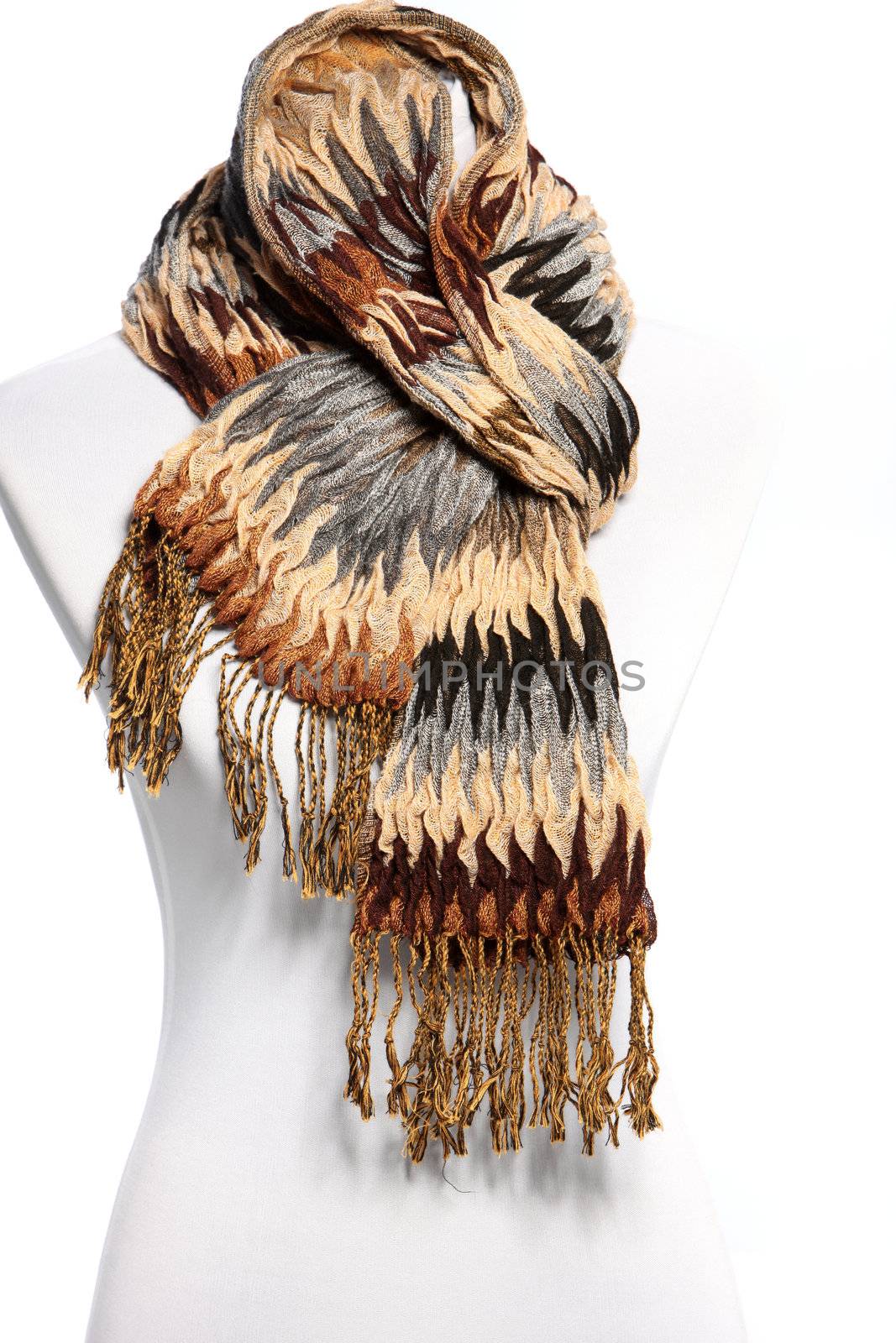 Mannequin in a soft cuddly warm winter scarf with a zig-zag striped pattern in browns and greys and long luxurious tassels