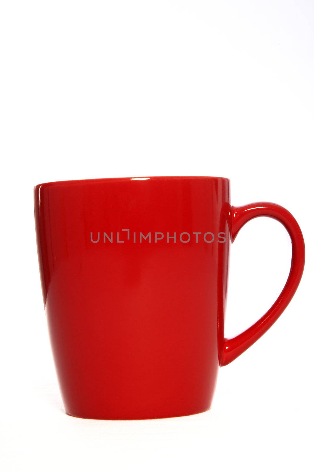 Closeup of a single red ceramic or pottery coffee mug isolated on white