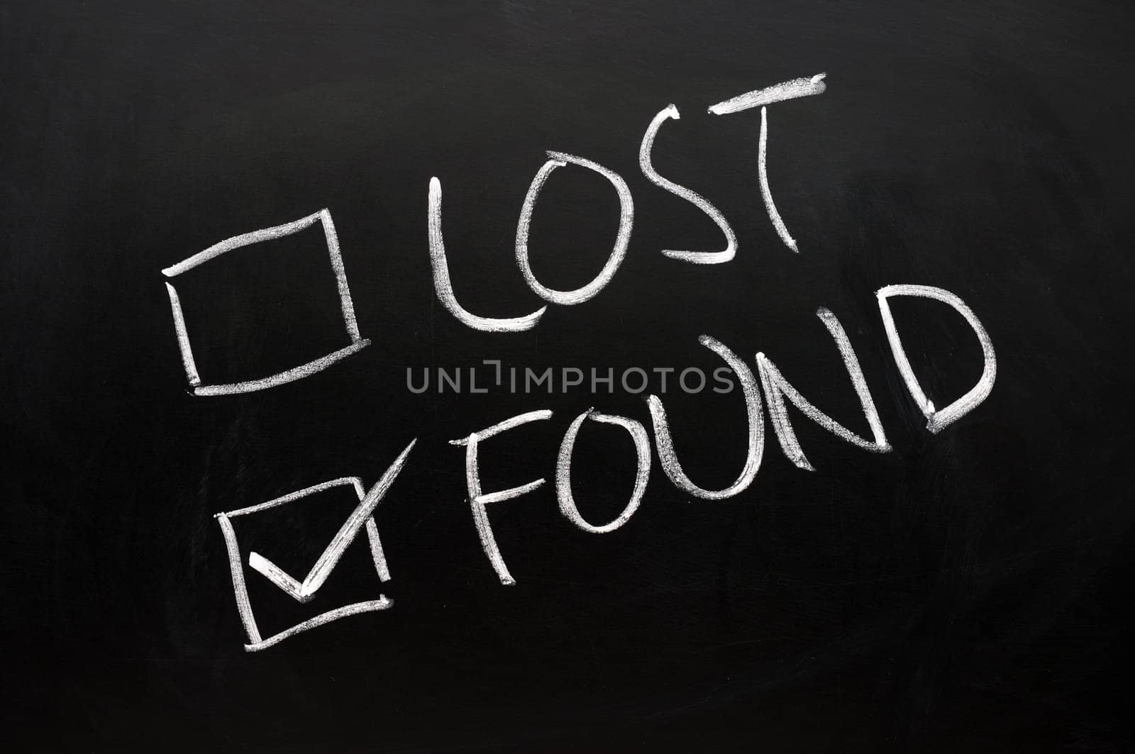 Lost and found check boxes written with chalk on a blackboard