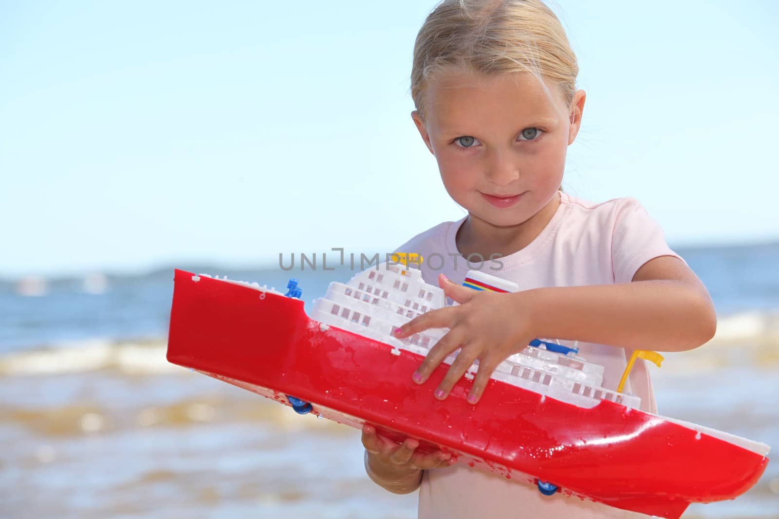 Girl playing with boat by phovoir