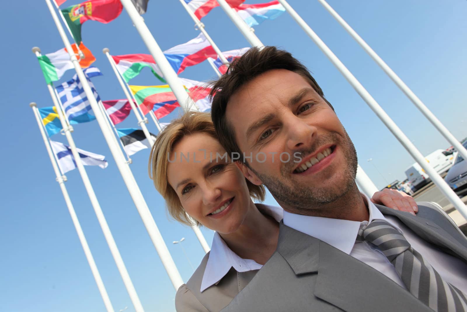 Businessman and woman with flags. by phovoir