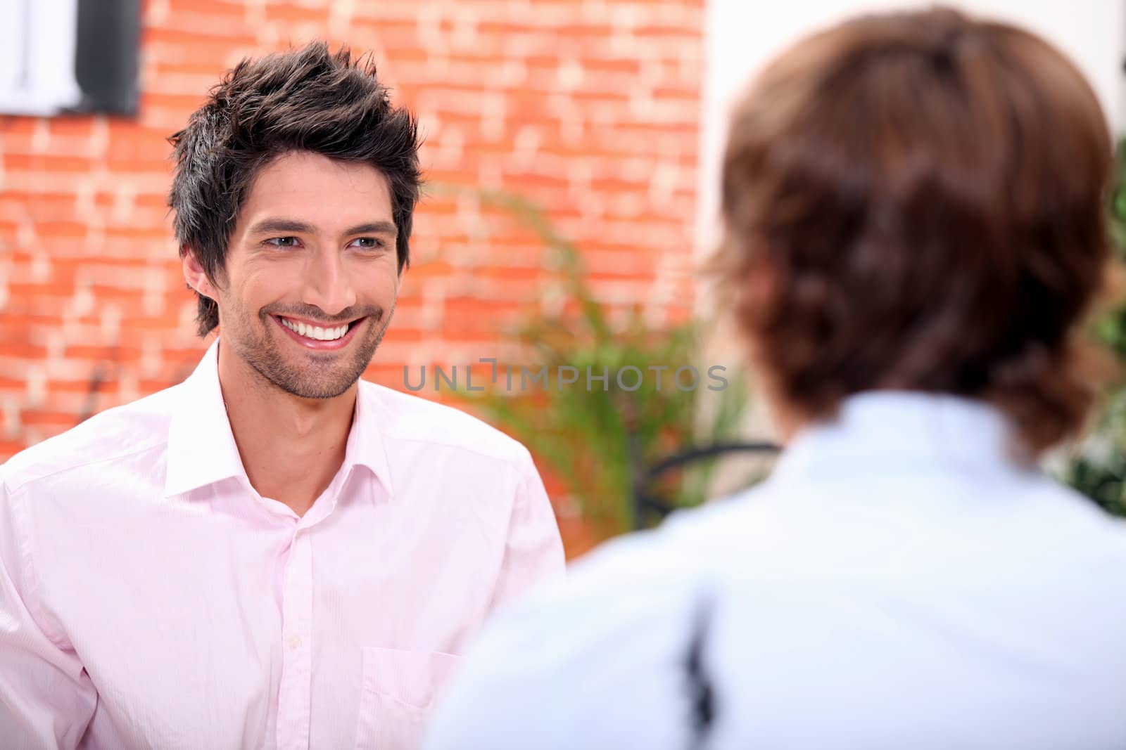 a man at restaurant with someone by phovoir