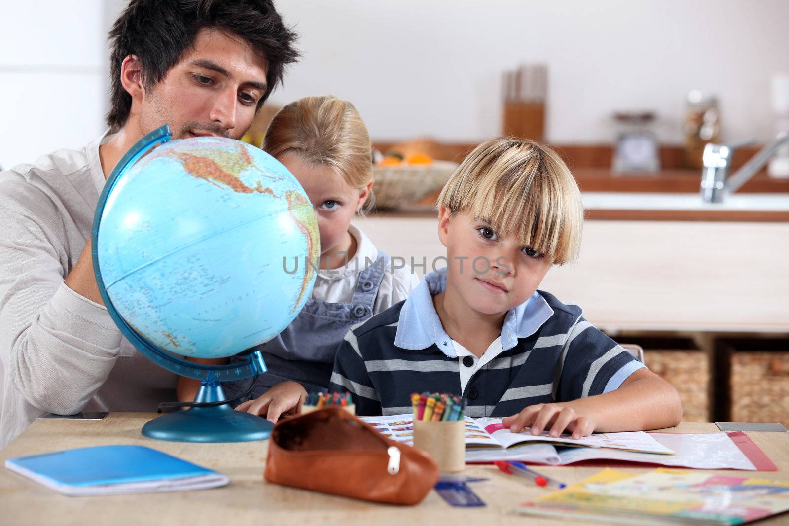 Brother and sister doing geography homework by phovoir