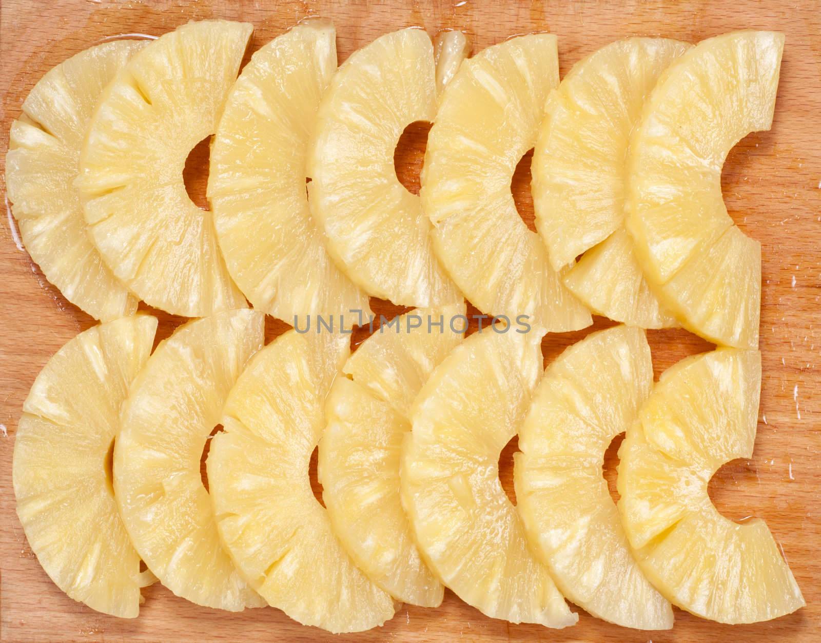 pineapple slices on wooden board close up