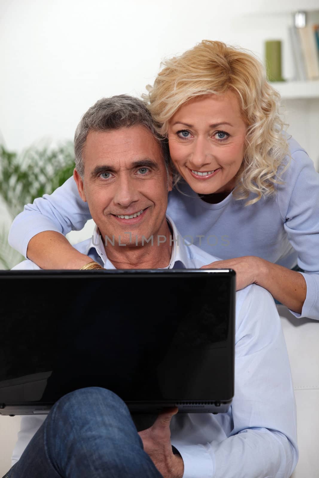 Mature couple with a laptop by phovoir