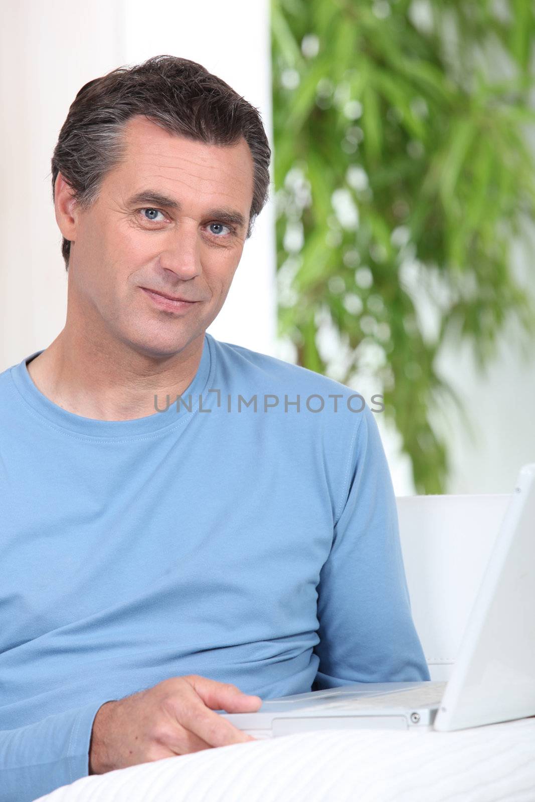 Man sat at table with computer