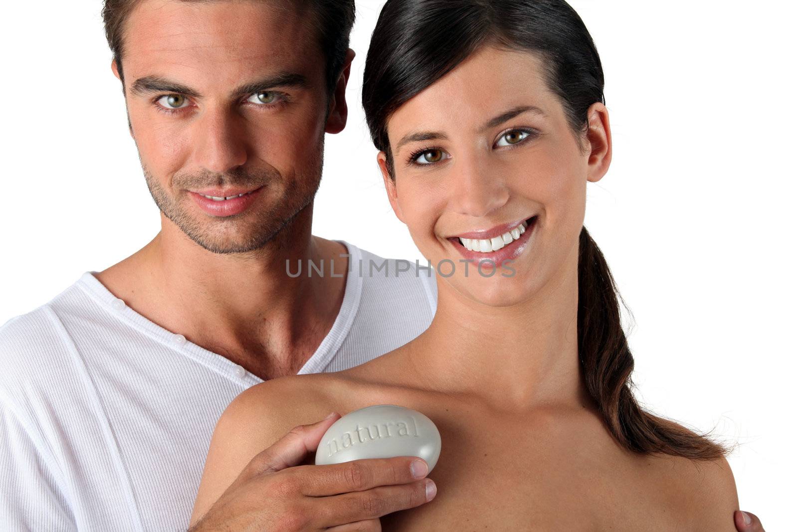 Couple in studio holding pebble