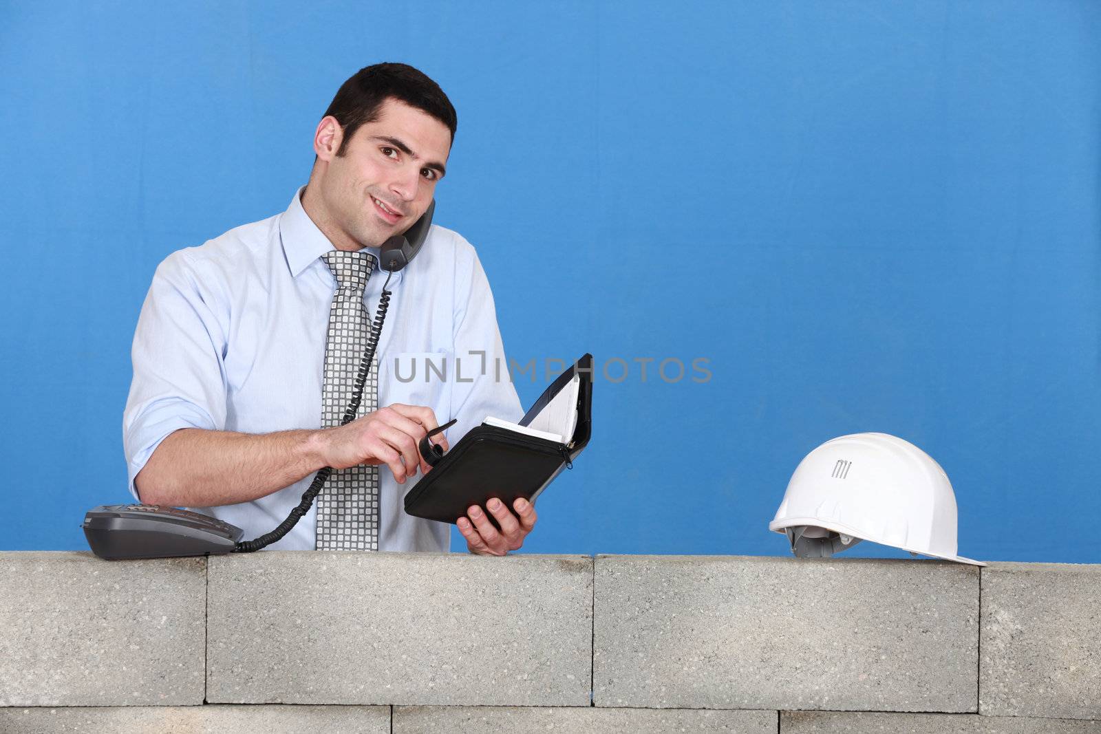 construction businessman talking on the phone by phovoir