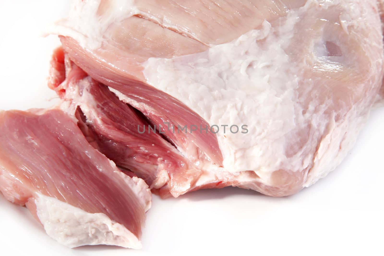 Slices of fresh raw meat cut from a beef piece, close up